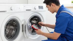 Professional appliance repair technician inspecting an open washing machine housing with diagnostic tools in a home.